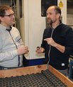 Mogens Christensen (left) is conducting research to develop more efficient and sustainable magnets. Among those he is working with is Peter Kjeldsteen (right), head of development at the company Sintex. The black rings in the picture are magnets for elect