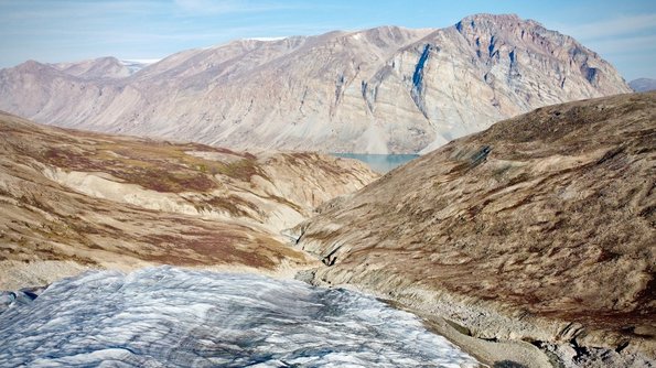 Glacier looking out over the fjord.  Mountain on the right was what we needed to summit to access the glacial valley (Photo: Henry Henson) ©